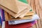 Stack of colorful envelopes on wooden table, closeup. Mail service