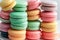 A stack of colorful macaroons on a plate