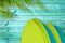 Stack of colorful surfboards on a tropical blue wood planks background with palm tree