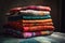 a stack of colorful textiles and fabric, ready to be made into a new project