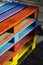 Stack of colorful wooden pallets outside