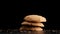 Stack of cookies falling on table.