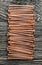 Stack of copper nails on wooden board
