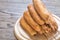 Stack of corn dogs on the wooden board