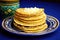 a stack of corn tortillas on a blue ceramic plate