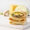 Stack of crepes with cabbage, mushrooms and cheese filling