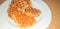 Stack of Croissant Waffle or Croffle served in white plate and wooden background