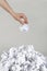 Stack of crumpled paper balls and hand