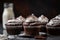 stack of decadent chocolate cupcakes with fluffy frosting and sprinkling of powdered sugar