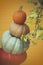 Stack of decorative pumpkins with textured background
