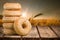 Stack of delicious doughnuts on wooden table