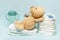 Stack of diapers with cute teddy bear,toy pacifier bottle lying on table. set for infant newborn boy girl for baby shower present