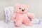 Stack of diapers or nappies with pink teddy bear