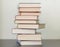 A stack of different books in a thick cover on the table