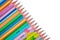 Stack of different colored wood pencil crayons placed on a white background