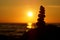 Stack of different stones in balance at the beach sunset