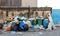Stack of different types of large garbage dump, plastic bags, and trash bins near a wall in urban area in Environmental pollution