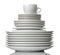 A stack of dishes. Dinnerware. plates and cup on a white isolated background. close-up