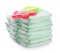 Stack of disposable diapers and teether on white background