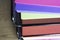 Stack of documents on brightly colored paper on stacked tray on office table
