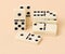 A stack of dominoes on a beige background, an intellectual game