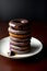 A Stack Of Donuts Sitting On Top Of A White Plate. Generative AI
