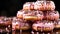 A stack of doughnuts with chocolate pink color background