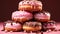 A stack of doughnuts with chocolate pink color background