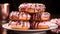 A stack of doughnuts with chocolate pink color background