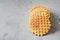 A stack of Dutch Belgian waffles with salted caramel on a gray background.