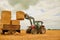 Stack em up. a farmer stacking hale bales with a tractor on his farm.