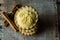 Stack of English mince pies on burlap cloth with cinnamon sticks, on a vintage wood box, top view, flat lay, close up