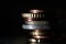 Stack of Euro coins illuminated from the side. Copper coins and golden coins. Dark background
