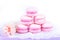 Stack of excellent airy macaroons. Stack of pink almond cakes on white background