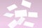 Stack of falling blank white business cards mock-up on pink background. 3D Render Illustration of realistic mockup design