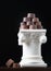Stack of Fine Artisan Chocolates Stacked On White Pillar Column