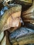 Stack of firewood logs with coarse bark.  Firewood stock.