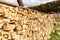 Stack of firewood. Wooden logs on autumn mountains. Woodpile background. Stacked wood. Wooden texture.