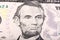 Stack of five U.S. Dollar. Close-up portrait of Abraham Lincoln.