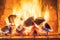 A stack of flaming firewood in a red mud brick fireplace in a country cottage