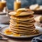 A stack of fluffy and golden pancakes with a pat of melting butter3