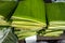 Stack of folded banana leaves displayed at a local market.