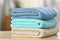 Stack of folded clean soft towels on table indoors