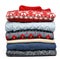 Stack of folded knitted sweaters in a store on white background