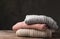 Stack of folded knitted sweaters on table