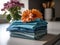 A stack of folded towels with flowers in the background. AI generative image.