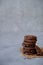 Stack of fresh homemade crispy cookies with dark chocolate.On a gray background. Copy space