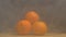 A stack of fresh and juicy tangerines that rotate on a black background and from which blows cool and evaporation, close