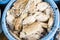 Stack of fresh squid in basket sold in fish dock market