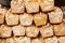 A stack of fresh tasty traditional brown square bread loafs with flour, bread pyramid like structure background texture